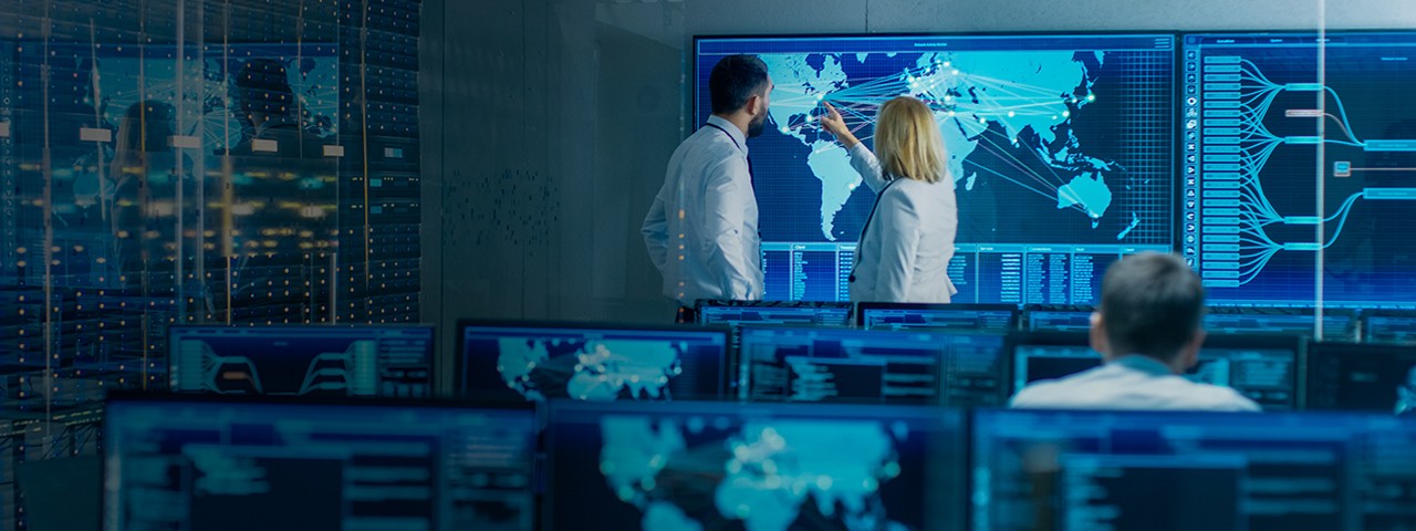 Two colleagues reviewing data in monitoring room